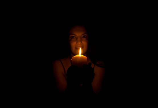 girl in the dark with a candel