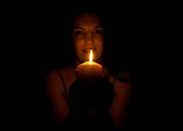 girl in the dark with a candel